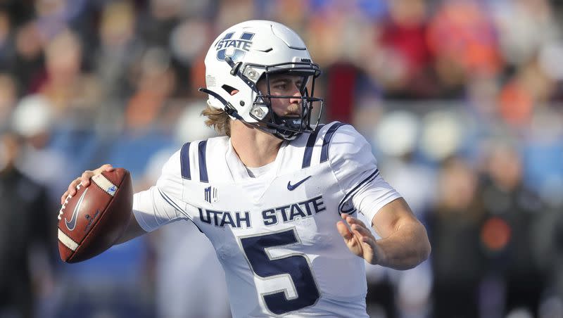 Utah State quarterback Cooper Legas (5) looks to throw the ball against Boise State in the first half of an NCAA college football game, Friday, Nov. 25, 2022, in Boise, Idaho.