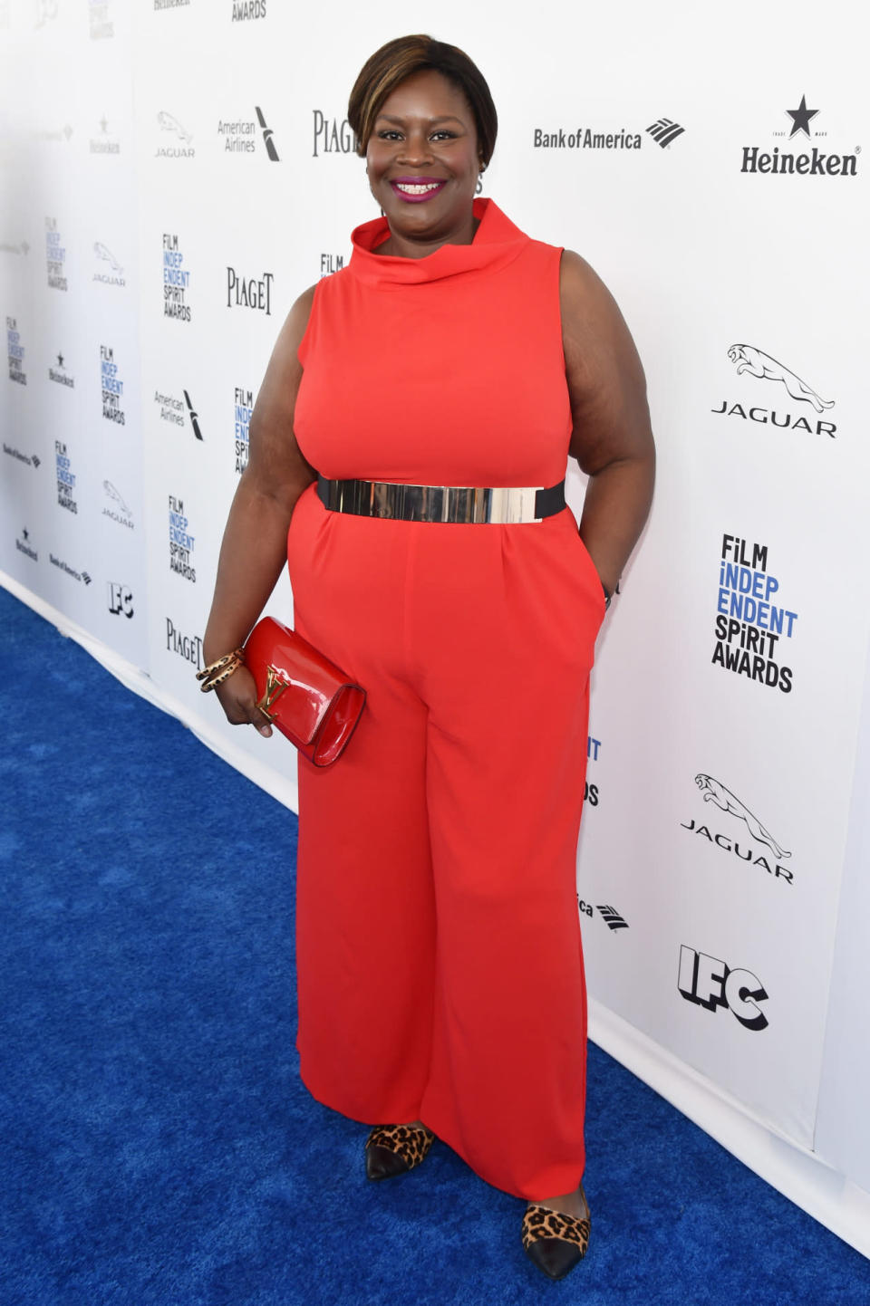 Retta in a red jumpsuit and cheetah print heels at the 2016 Film Independent Spirit Awards on February 27, 2016 in Santa Monica, California.