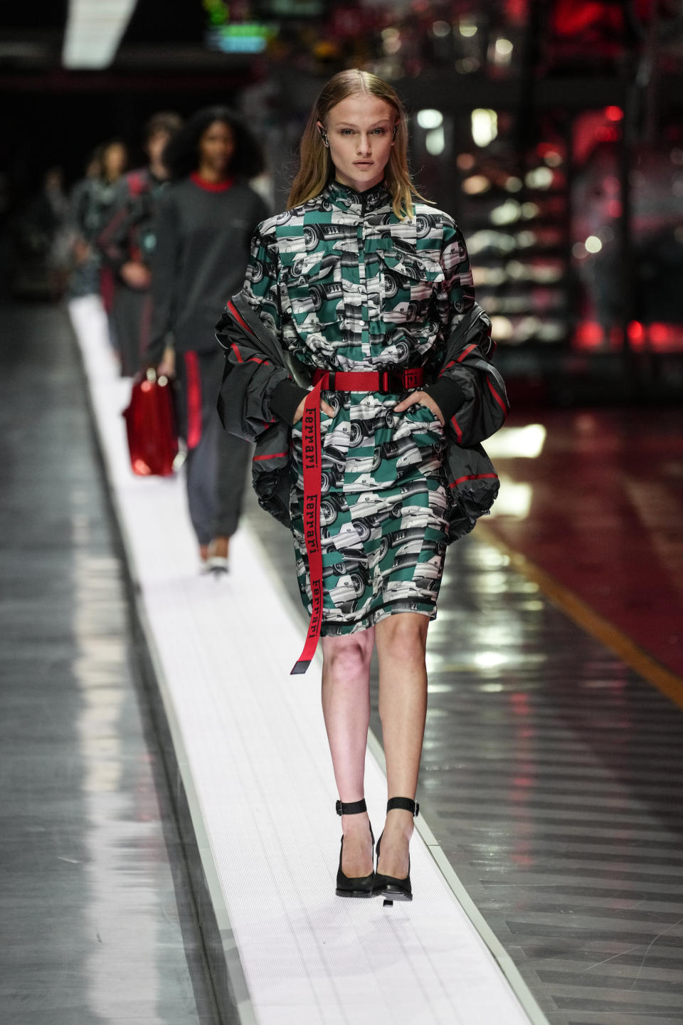 A model wears a creation as part of the Ferrari women's and men's Spring Summer 2022 collection, in Maranello, Italy, Sunday, June 13, 2021. (AP Photo/Antonio Calanni)