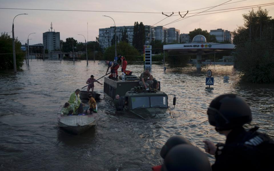 Residents are evacuated from a flooded neighborhood in Kherson, Ukraine - Felipe Dana/AP