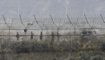 South Korean army soldiers patrol along the barbed-wire fence in Paju, South Korea, near the border with North Korea, Friday, Nov. 16, 2018. North Korean leader Kim Jong Un observed the successful test of "a newly developed ultramodern tactical weapon," the nation's state media reported Friday, though it didn't describe what sort of weapon it was.(AP Photo/Ahn Young-joon)