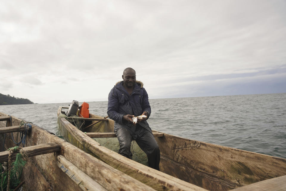 Fisherman Alfred Ojah shows holds his catch after fishing for hours in the Atlantic, near Limbe, Cameroon, on April 12, 2022. In recent years, Cameroon has emerged as one of several go-to countries for the widely criticized “flags of convenience” system, under which foreign companies can register their ships even though there is no link between the vessel and the nation whose flag it flies. But experts say weak oversight and enforcement of fishing fleets undermines global attempts to sustainably manage fisheries and threatens the livelihoods of millions of people in regions like West Africa. (AP Photo/Grace Ekpu)