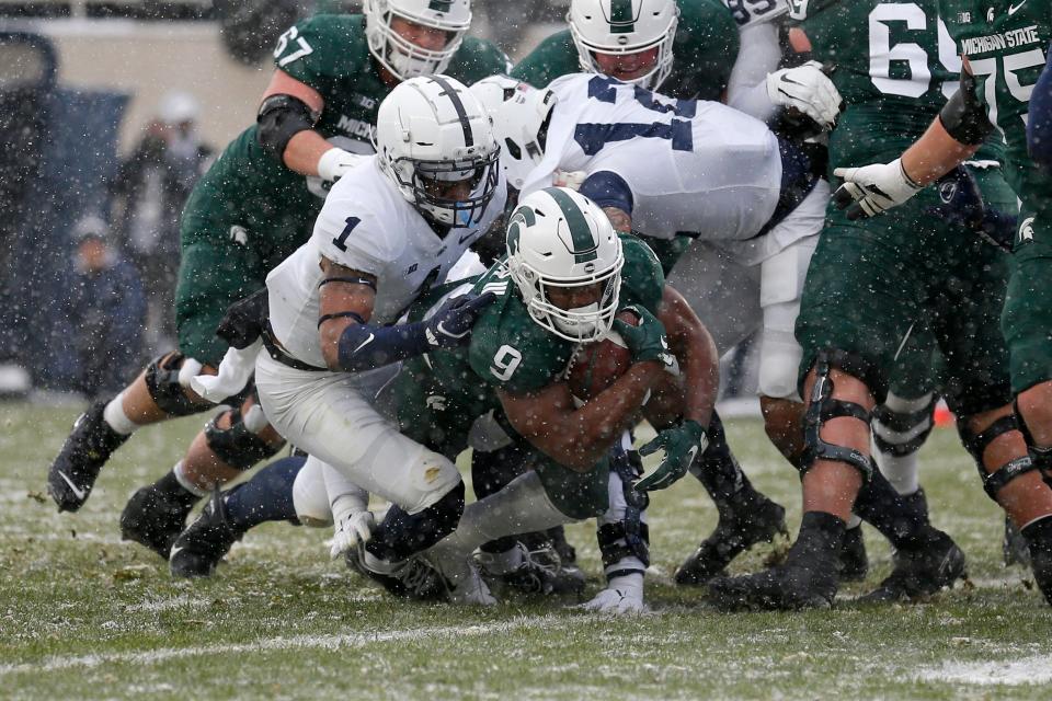 Michigan State's Kenneth Walker III rushes for a touchdown against Penn State's Jaquan Brisker during the first quarter on Saturday, Nov. 27, 2021, in East Lansing.