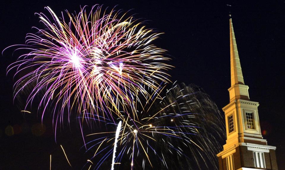Fireworks explode in the sky behind the First United Methodist Church during the July 4th celebration in 2014.
