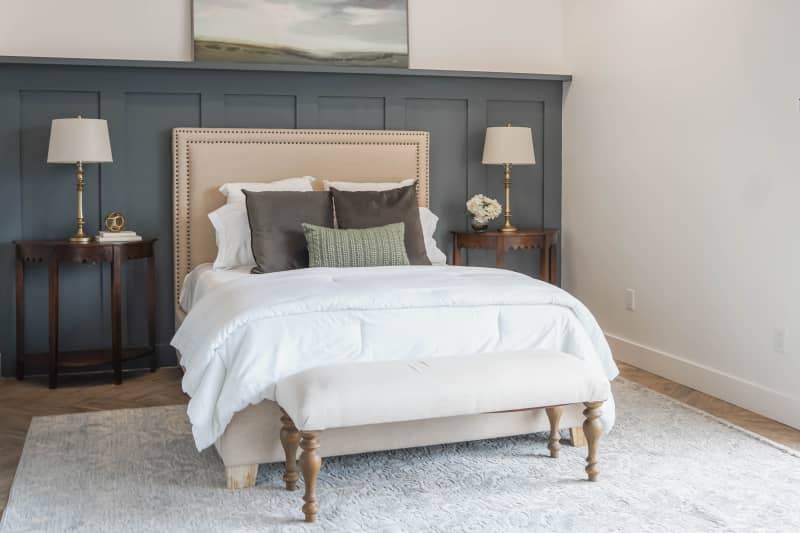 White bedroom with gray accent wall after home staging