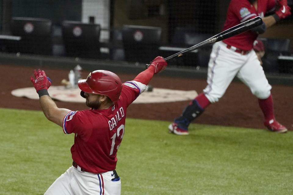 Texas Rangers' Joey Gallo follows through on a fielder's choice swing that came off a pitch from Houston Astros' Brooks Raley in the 10th inning of a baseball game in Arlington, Texas, Friday, Sept. 25, 2020. Rangers' Isiah Kiner-Falefa scored. (AP Photo/Tony Gutierrez)