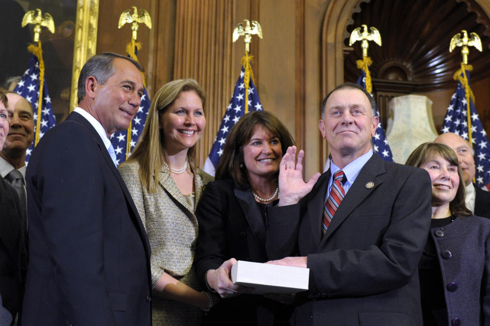 FILE - In this Jan. 5, 2011, file photo, House Speaker John Boehner, left, of Ohio reenacts the swearing in of Rep. Richard Hanna, R-N.Y., on Capitol Hill in Washington. Hanna, a moderate Republican from upstate New York who broke with his party in 2016 over supporting then-candidate Donald Trump, died Sunday, March 15, 2020, after a battle with cancer, his family said. He was 69. (AP Photo/Susan Walsh, File)