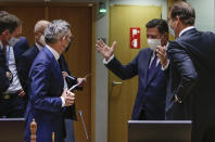 Minister of State for Europe at the German Federal Foreign Office Michael Roth, third left, speaks with Greek Foreign Affairs Minister in charge of European Affairs Miltiadis Varvitsiotis, center, and Permanent Representative of Austria Nikolaus Marschik, right, during a meeting of the General Affairs Council at the European Council building in Brussels, Tuesday, Sept. 22, 2020. European Union ministers meet Tuesday to discuss the stalemate in the Brexit negotiations and prospects to avoid a no-deal cliff-edge transition at the end of the year. (Aris Oikonomou, Pool via AP)