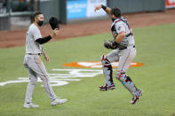 Miami Marlins catcher Francisco Cervelli, right, and designated hitter Matt Joyce celebrate after defeating the Baltimore Orioles 1-0 during game one of a baseball double-header, Wednesday, Aug. 5, 2020, in Baltimore. (AP Photo/Julio Cortez)