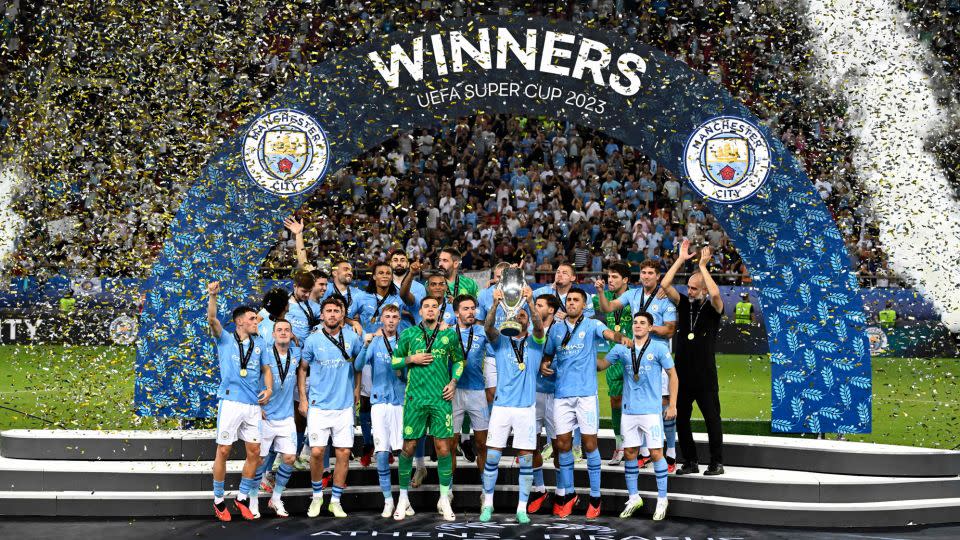 Manchester City players celebrate on the podium after winning the UEFA Super League. - Aris Messinis/AFP/Getty Images
