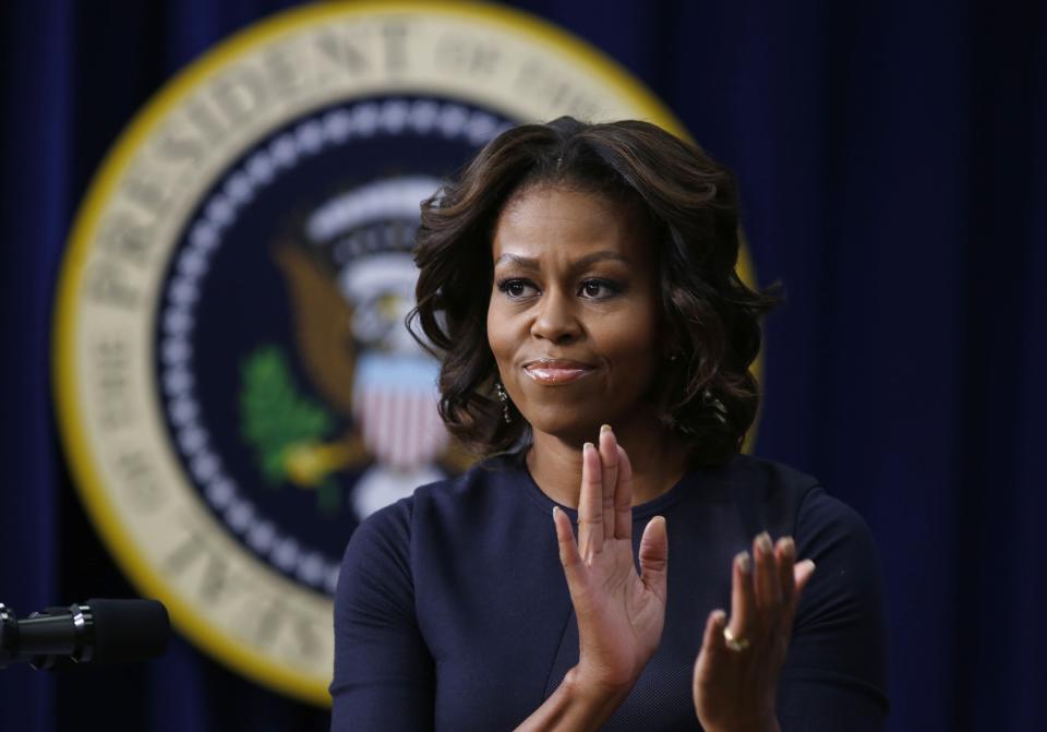 U.S. first lady Obama applauds as she gives remarks at an event on Expanding College Opportunity in Washington