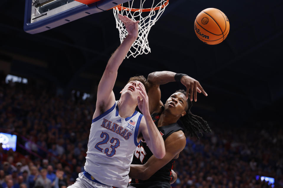 Kansas forward Parker Braun (23) is unable to score against Houston forward Joseph Tugler, right, during the first half of an NCAA college basketball game, Saturday, Feb. 3, 2024, in Lawrence, Kan. (AP Photo/Colin E. Braley)