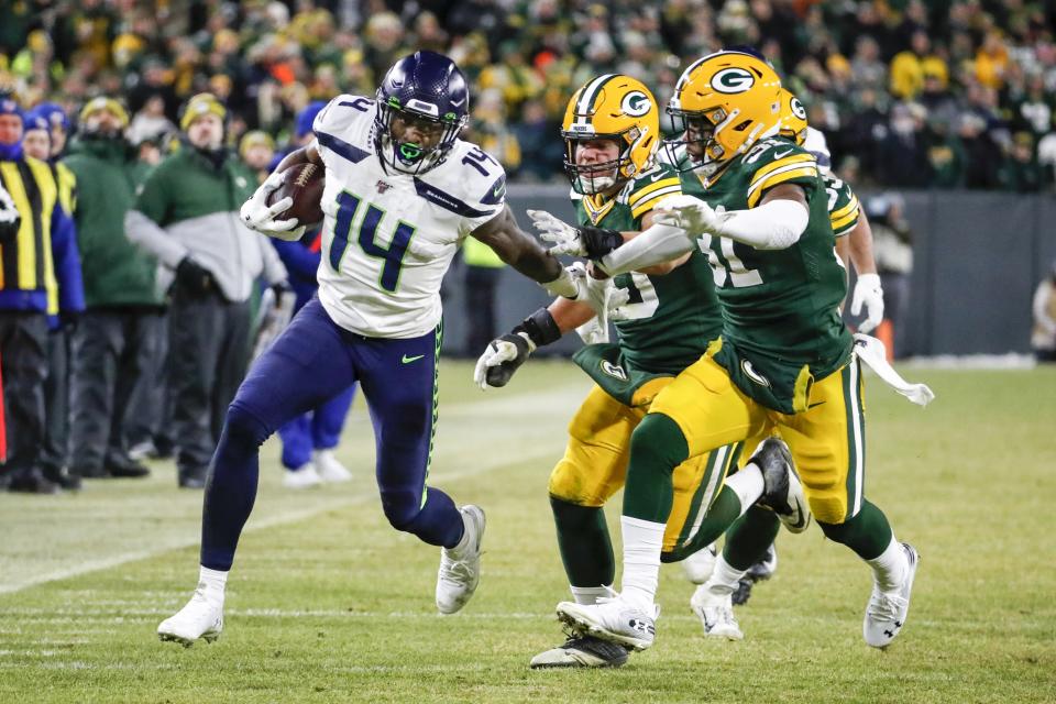 Seattle Seahawks' DK Metcalf runs after a catch during the second half of an NFL divisional playoff football game against the Green Bay Packers Sunday, Jan. 12, 2020, in Green Bay, Wis. (AP Photo/Matt Ludtke)