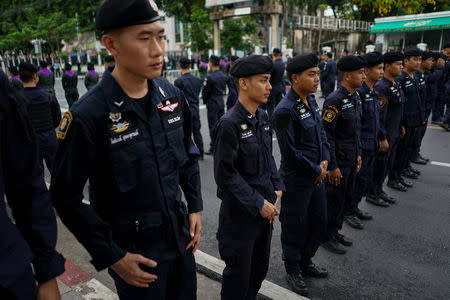 Police officers stand guard near a university where anti-government protesters gather to demand that the military government hold a general election by November, in Bangkok, Thailand, May 22, 2018. REUTERS/Athit Perawongmetha