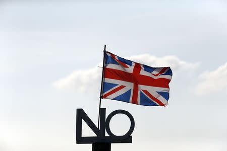 A "No" campaign placard and Union flag are seen outside a cottage on the Isle of North Uist, in the Outer Hebrides of Scotland, in this September 15, 2014 file photo. REUTERS/Cathal McNaughton/Files