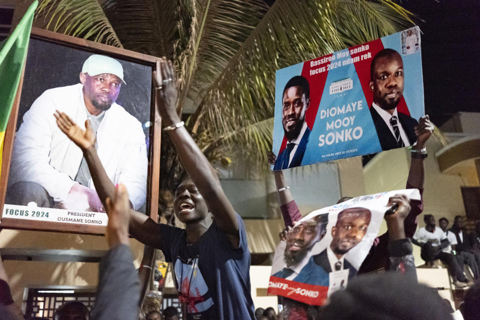 Supporters celebrate the release of Senegal's top opposition leader Ousmane Sonko and his key ally Bassirou Diomaye Faye outside Sonko's home in Dakar, Senegal, Thursday, March 14, 2024. Sonko had been in prison since July 2023 and has fought a prolonged legal battle to run for president in the March 24 election.(AP Photo/Sylvain Cherkaoui)