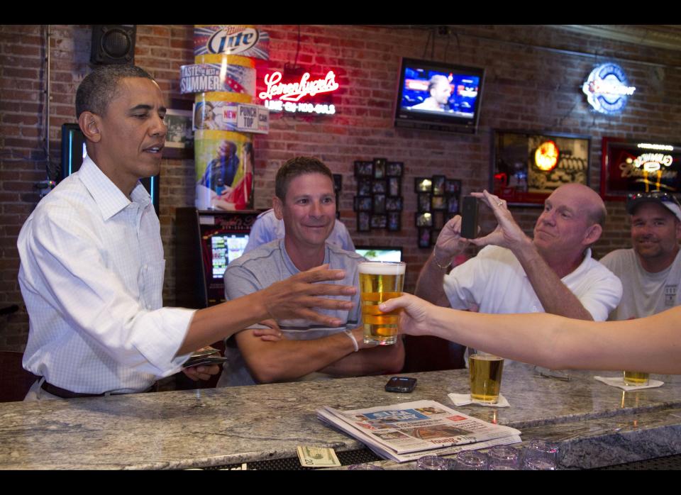 Obama stops for a beer at The Pump House, a pub and grill, Tuesday, Aug. 14, 2012, in Cedar Falls, Iowa, during a three day campaign bus tour through Iowa. (AP Photo/Carolyn Kaster)