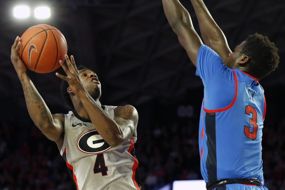 Georgia's Tyree Crump (4) shoots while being defended by Mississippi forward Khadim Sy (3) during an NCAA college basketball game in Athens, Ga., Saturday, Jan. 25, 2020. (Joshua L. Jones/Athens Banner-Herald via AP)