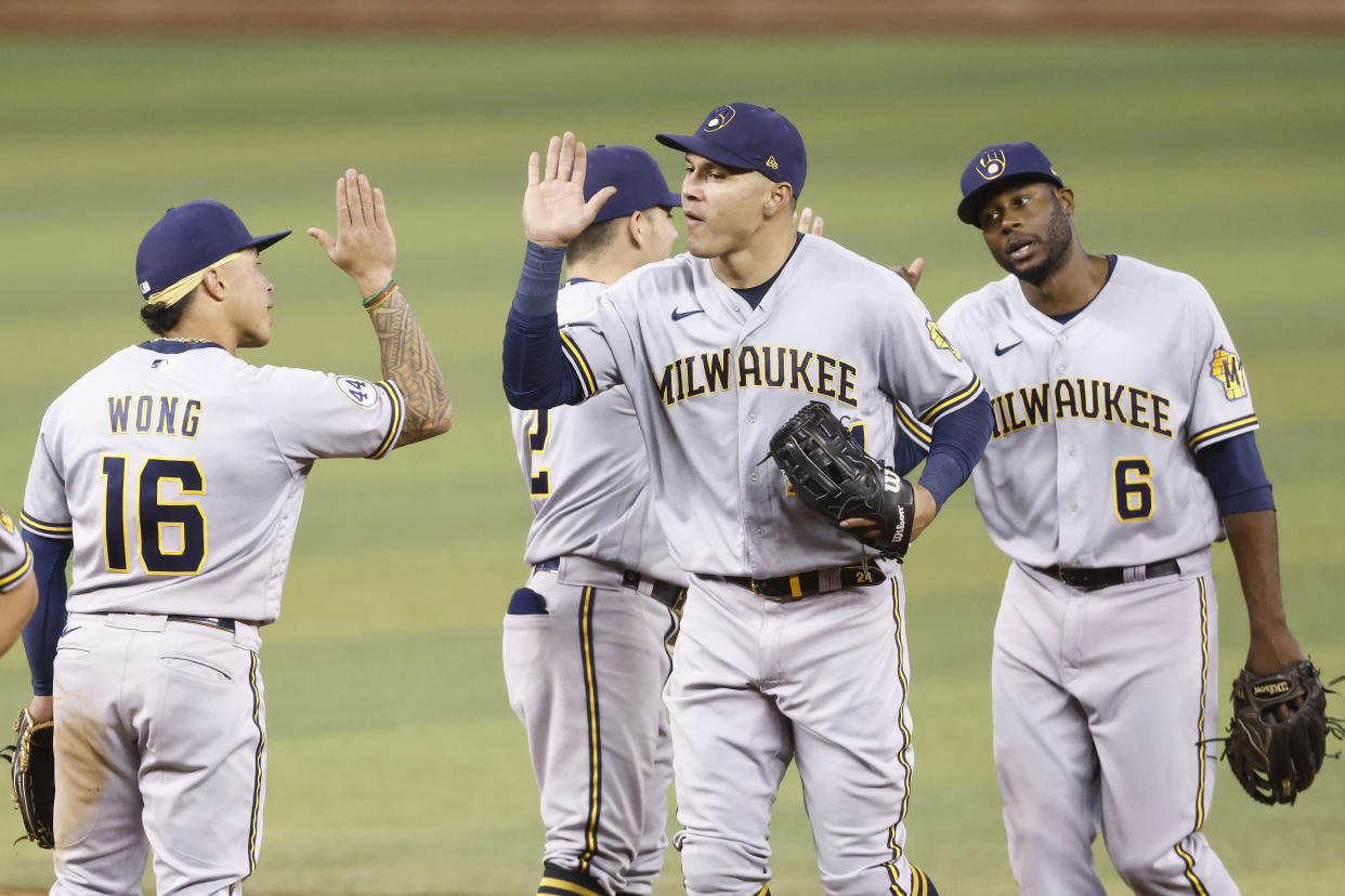 MIAMI, FLORIDA - MAY 08: Avisail Garcia #24 of the Milwaukee Brewers celebrates with Kolten Wong #16 after defeating the Miami Marlins 6-2 at loanDepot park on May 08, 2021 in Miami, Florida. (Photo by Michael Reaves/Getty Images)