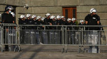 Riot police guards the area in front of the Serbian Parliament building as people gather for a demonstration in Belgrade, Serbia, Wednesday, July 8, 2020. Serbia's president Aleksandar Vucic backtracked Wednesday on his plans to reinstate a coronavirus lockdown in Belgrade after thousands protested the move and violently clashed with the police in the capital. (AP Photo/Darko Vojinovic)