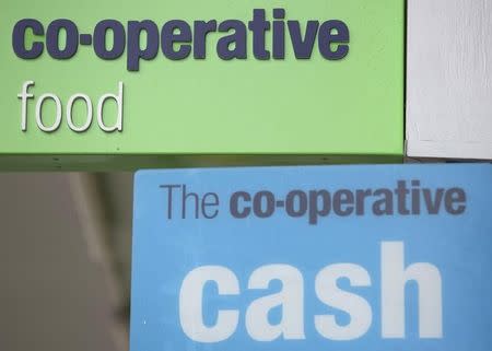 Signs are displayed outside of a branch of a Co-operative food store in north London April 17, 2014. REUTERS/Neil Hall