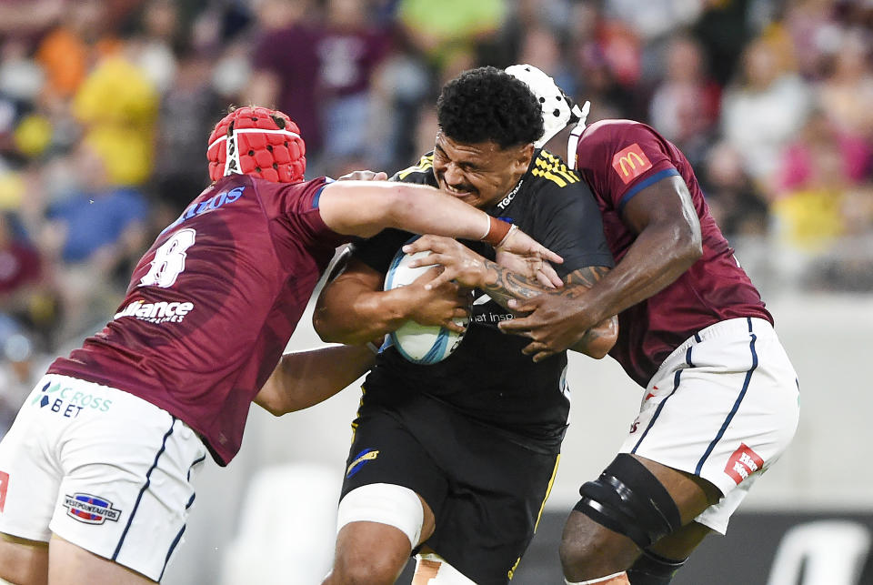 Isaia Walker-Leawere of the Hurricanes runs with the ball during the Super Rugby Pacific Round 1 match between the Queensland Reds and the Hurricanes at Queensland Country Bank Stadium in Townsville, Australia Saturday, Feb. 25, 2023. (Scott Radford-Chisholm/AAP Image)
