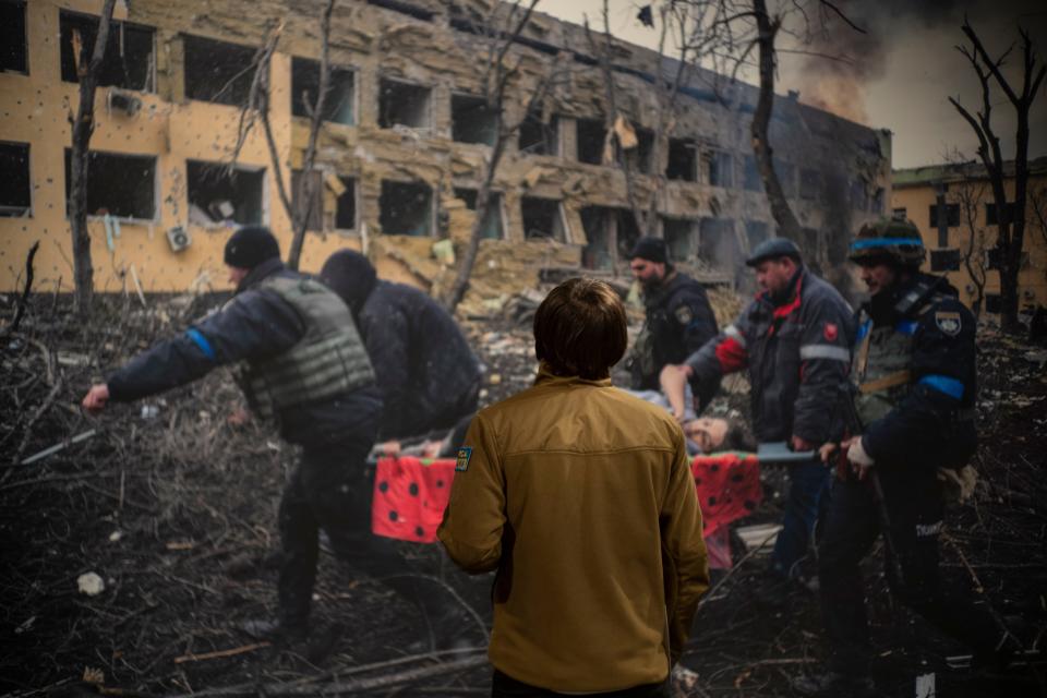 World Press Photo of the Year award winner, Associated Press photographer Evgeniy Maloletka, looks at his winning image of a pregnant woman being carried through the wreckage of a maternity hospital after a Russian military strike in Mariupol, Ukraine, prior to a press conference announcing the winners in Amsterdam, Netherlands, Thursday, April 20, 2023.