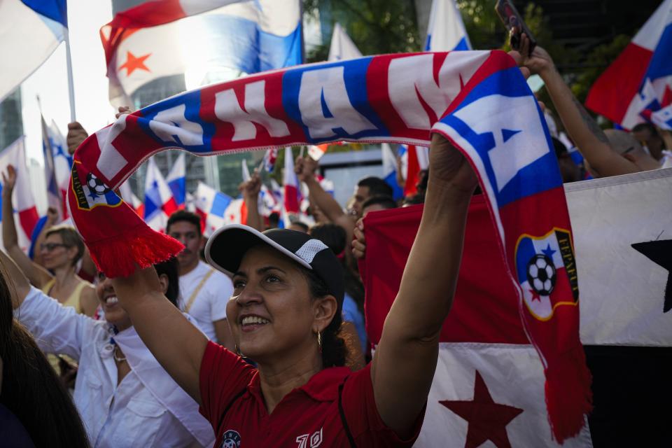 Panamanians celebrate after the Supreme Court declared a 20-year contract with a Canadian copper mine unconstitutional, in Panama City, Tuesday, Nov. 28, 2023. Panama's Supreme Court ruled unanimously that the concession that has been the focus of widespread environmental protests was unconstitutional, after which the president of the Central American country said the process to close the mine would begin. (AP Photo/Arnulfo Franco)