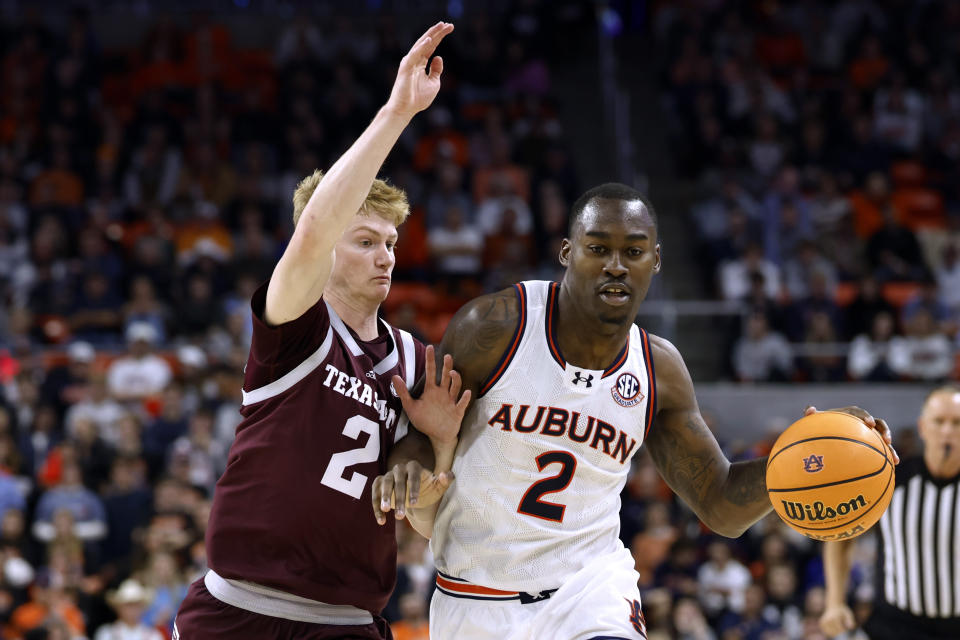 Auburn forward Jaylin Williams, right, drives around Texas A&M guard Hayden Hefner during the second half of an NCAA college basketball game Tuesday, Jan. 9, 2024, in Auburn, Ala. (AP Photo/Butch Dill)