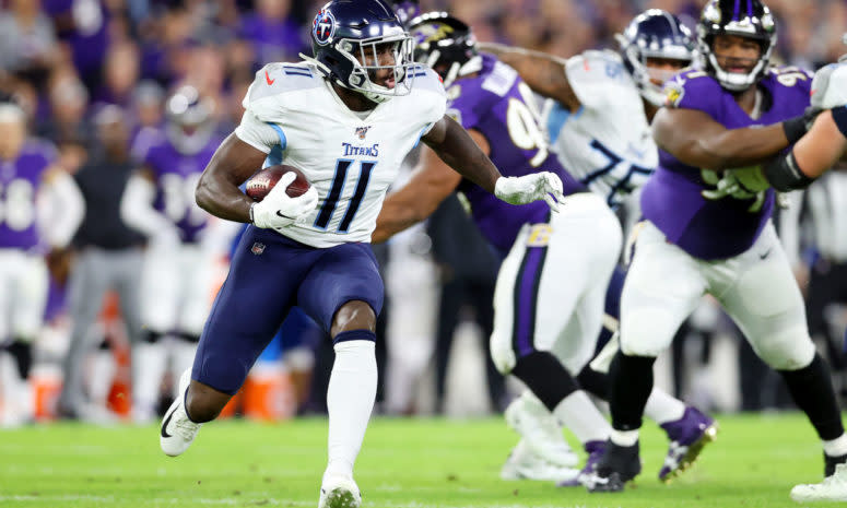 Tennessee Titans wide receiver A.J. Brown carries the ball in an NFL game.