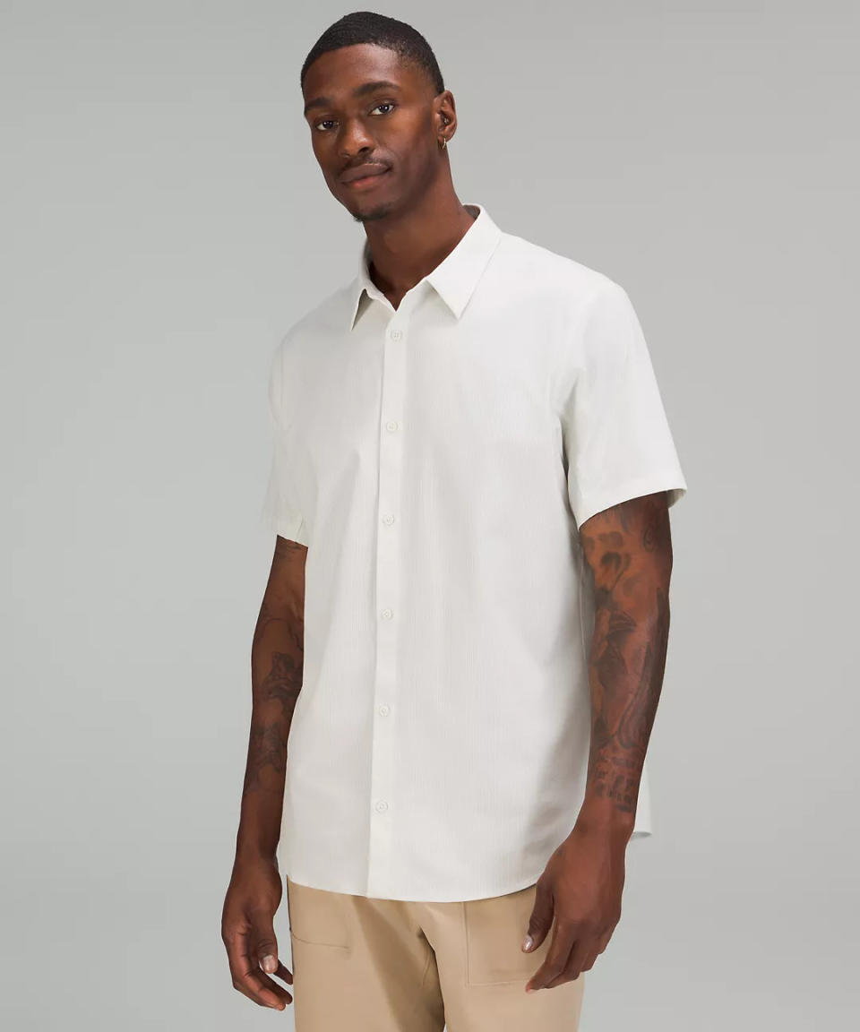 man wears white lululemon Airing Easy Short Sleeve Shirt. 