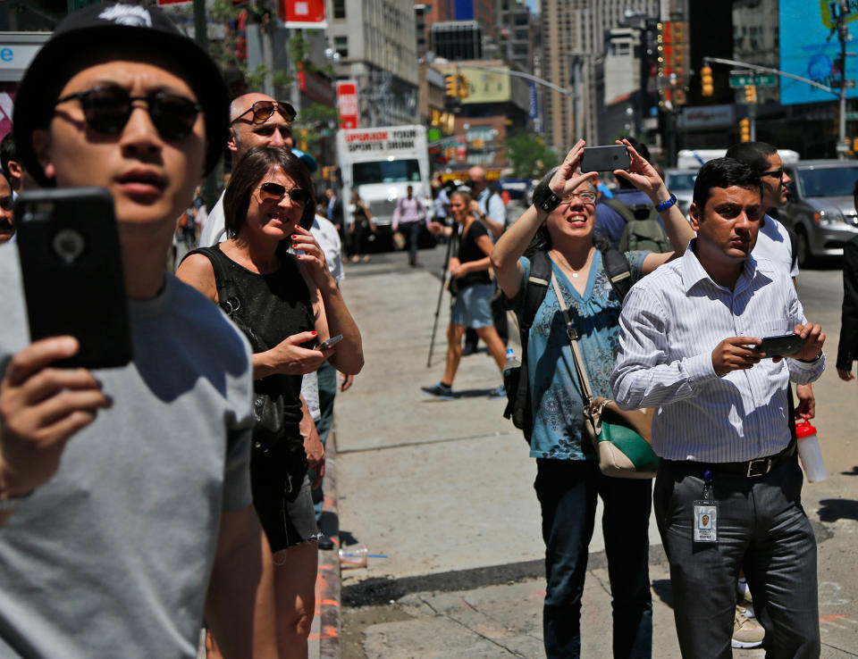 <p>Pedestrians try to get a look at a car crash in Times Square in New York, Thursday, May 18, 2017. (AP Photo/Seth Wenig) </p>