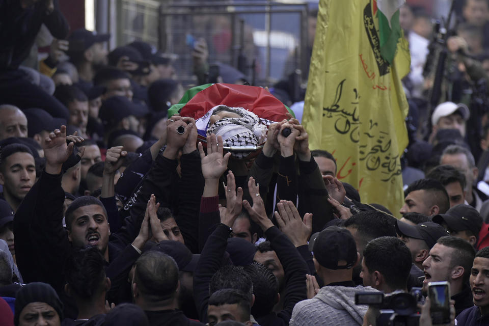 Palestinian mourners carry the body of Bakir Muhammad Musa Hashash, 21, who was killed by Israeli fire, during his funeral in Balata refugee camp near the West Bank town of Nablus, Thursday, Jan. 6, 2022. The Israeli military said its forces shot and killed Hashash, a Palestinian who had opened fire on them during an arrest raid in the West Bank early Thursday. (AP Photo/Majdi Mohammed)