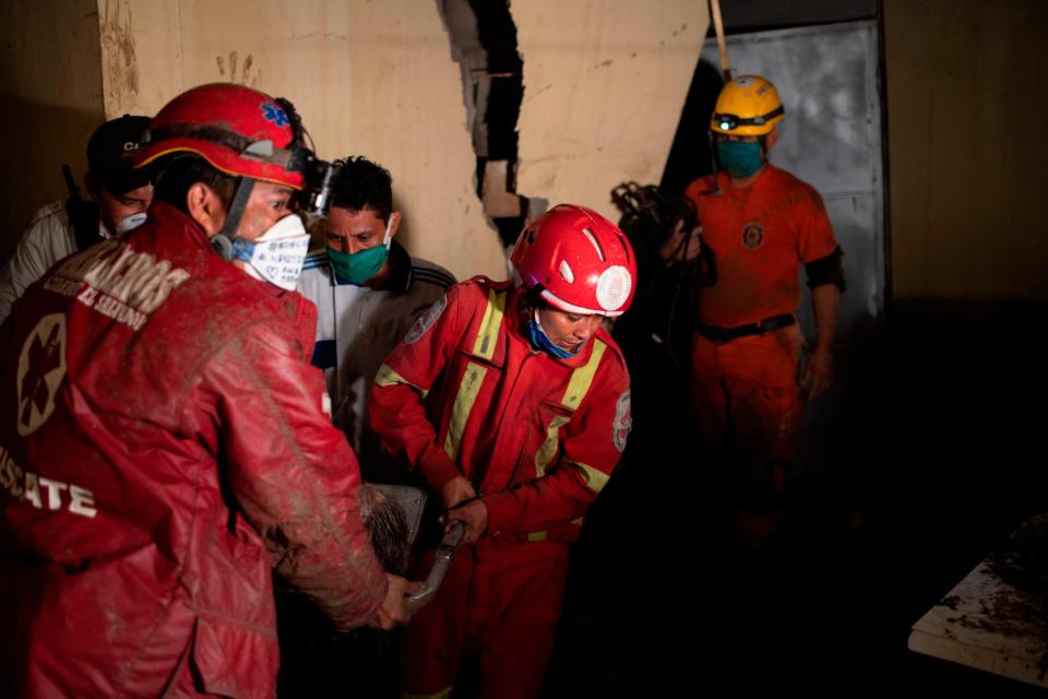 Rescue workers remove a survivor from a collapsed building (AFP via Getty Images)