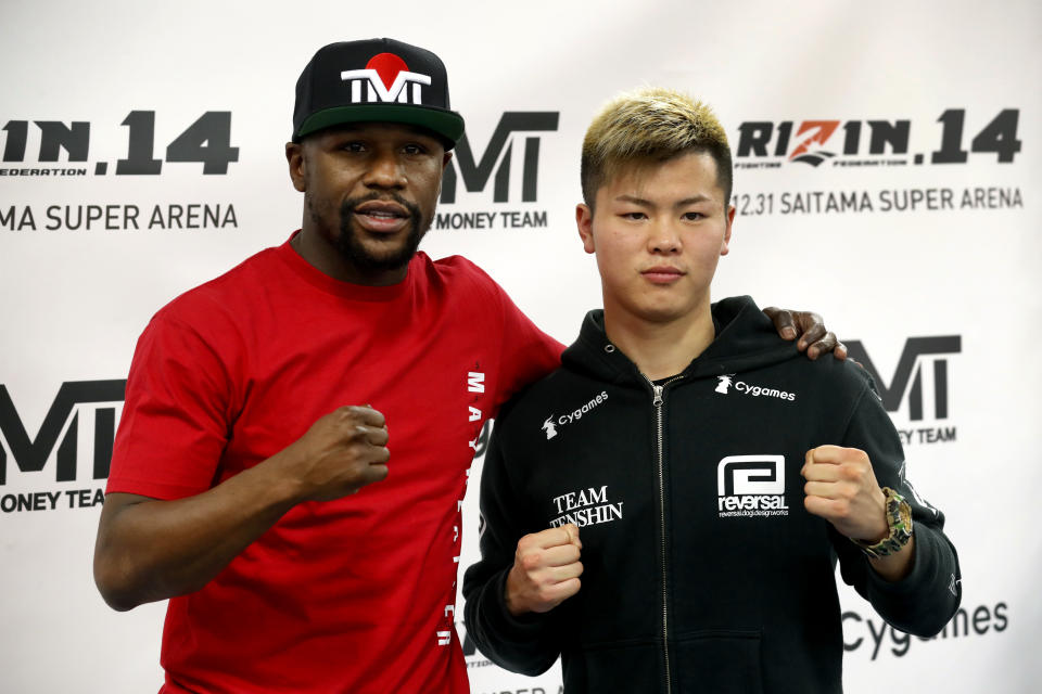 Floyd Mayweather Jr., left, poses with kickboxer Tenshin Nasukawa, of Japan, during a news conference at the Mayweather Boxing Club in Las Vegas, Thursday, Dec. 6, 2018. Mayweather is scheduled to fight Nasukawa in a three-round exhibition match in Japan on New Year's Eve. (Steve Marcus/Las Vegas Sun via AP)