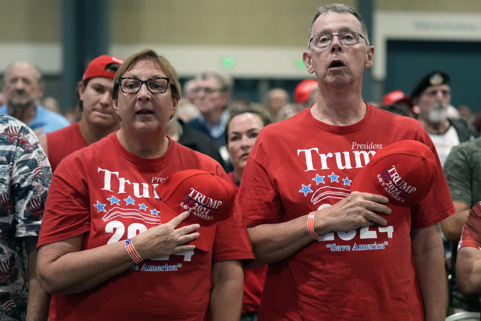 People stand for the Pledge of Allegiance before Republican presidential candidate former President Donald Trump speaks at his birthday celebration, hosted by Club 47, in West Palm Beach, Fla., Friday, June 14, 2024. (AP Photo/Gerald Herbert)