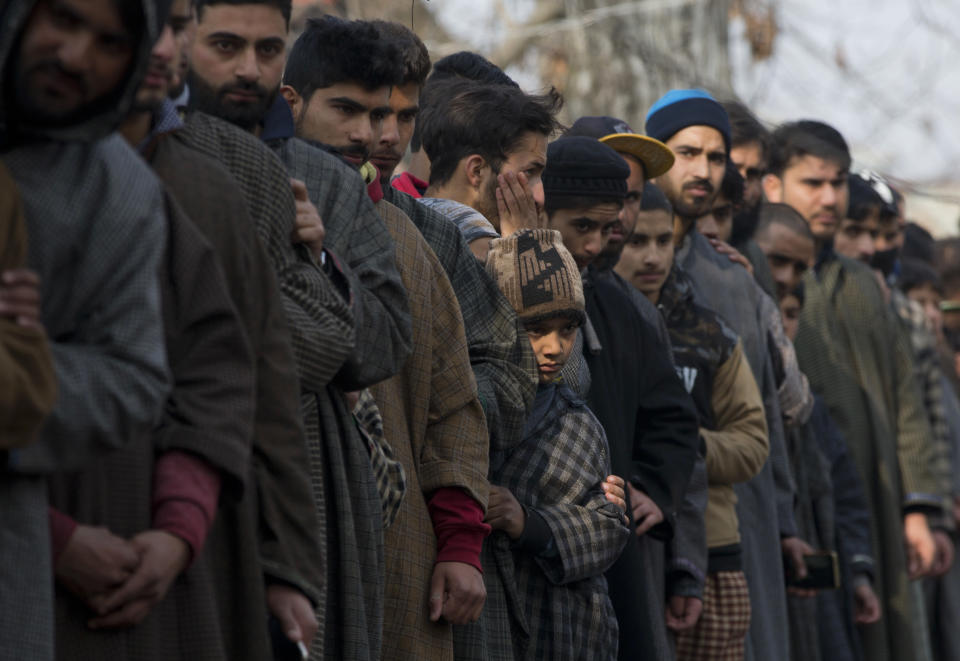 Kashmiri villagers watch the joint funeral procession of four rebels in Tral, south of Srinagar, Indian controlled Kashmir, Saturday, Dec. 22, 2018. A gunbattle between Indian troops and Kashmiri rebels early Saturday left six militants dead and triggered a new round of anti-India protests in the disputed Himalayan region. (AP Photo/Dar Yasin)