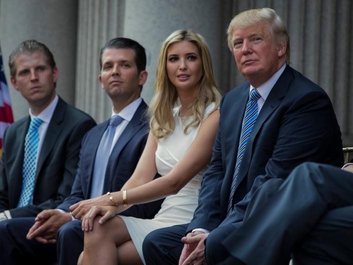 Donald Trump, right, sits with his children, from left, Eric Trump, Donald Trump Jr., and Ivanka Trump during a groundbreaking ceremony for the Trump International Hotel on July 23, 2014, in Washington.