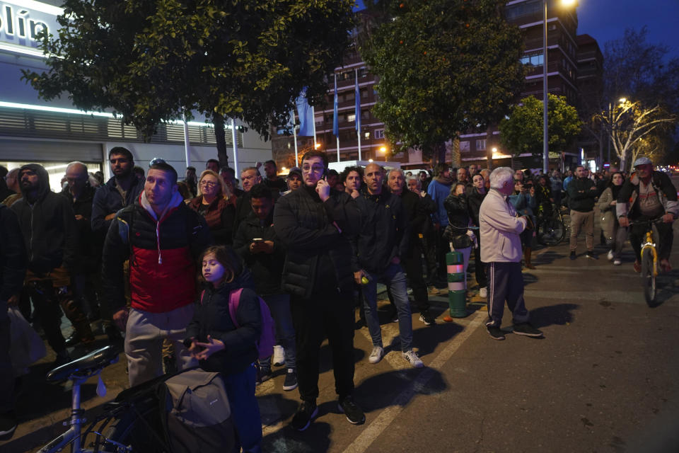 People watch as a housing block burns in Valencia, Spain, Thursday, Feb. 22, 2024. The cause of the fire is unknown and if there are any victims. (AP Photo/Alberto Saiz)