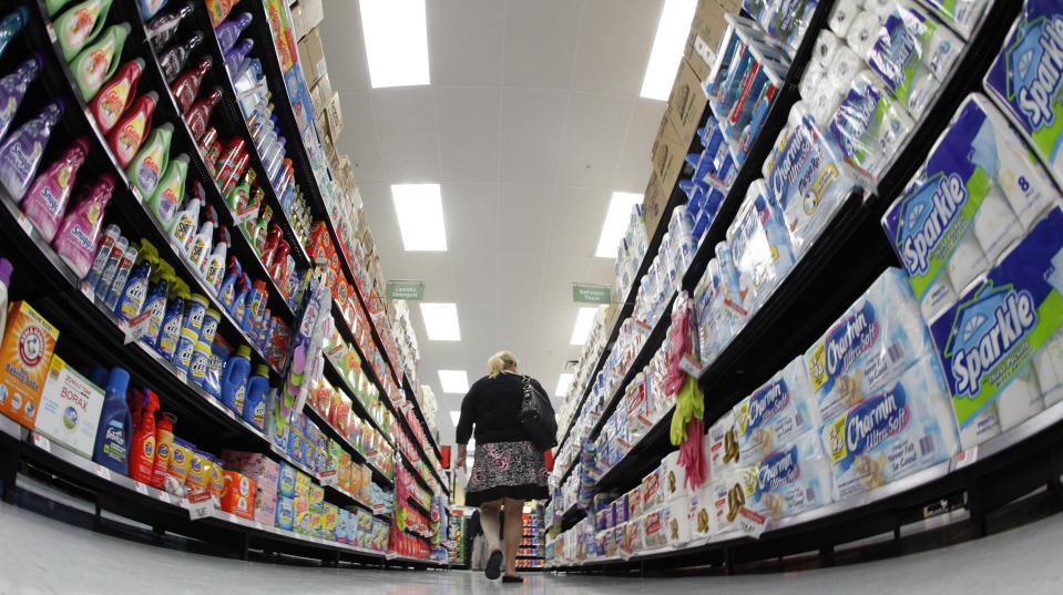 A shopper walks down an aisle in a newly opened Walmart Neighborhood Market in Chicago September 21, 2011. The 27,000 square foot (2508 square meters) store is the first in Illinois with an emphasis on groceries and basic household goods.  REUTERS/Jim Young      (UNITED STATES - Tags: FOOD BUSINESS)