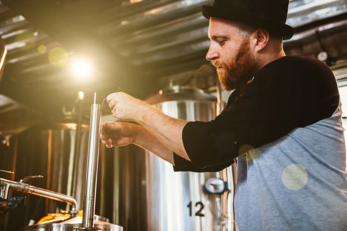 A craft brewer sampling beer