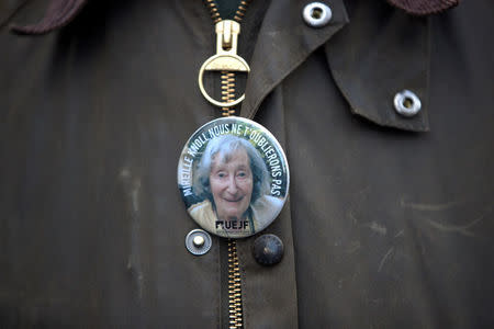 A pin with a portrait of Mireille Knoll is seen on a man's jacket during a gathering, in Paris, France, March 28, 2018. REUTERS/Gonzalo Fuentes