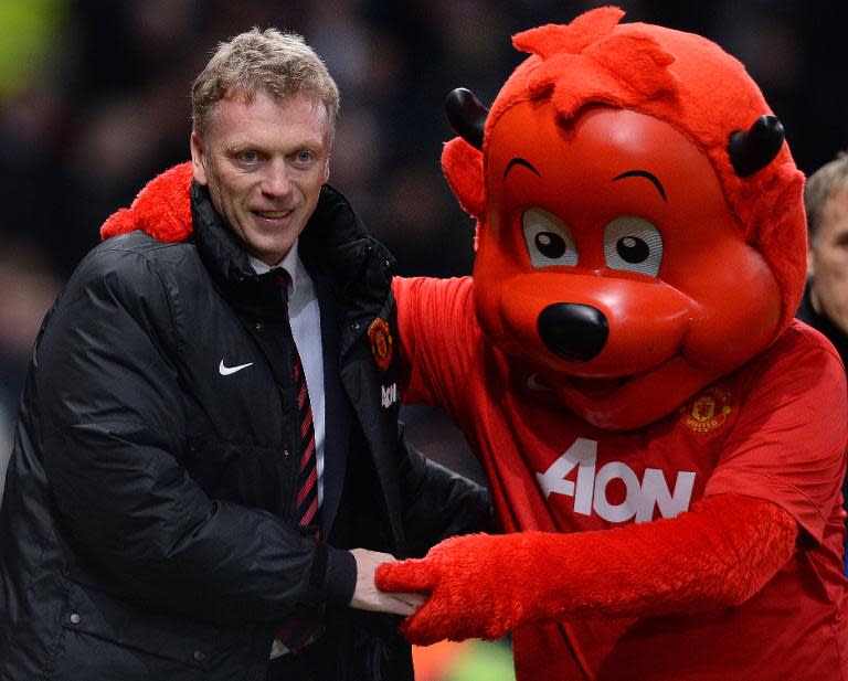 Manchester United's Scottish manager David Moyes is greeted by mascot Fred The Red at Old Trafford in Manchester, on January 11, 2014