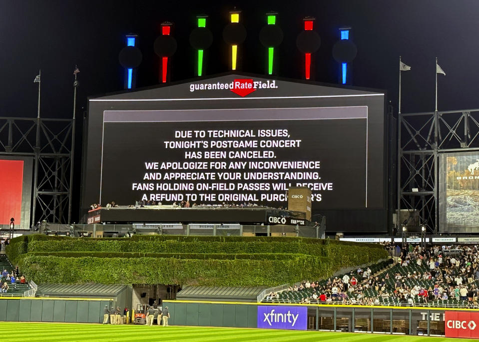 A message on the main scoreboard at Guaranteed Rate Field announces the cancellation of an 90s concert that was to feature Vanilla Ice, Tone Loc, and Rob Base after a baseball game between the Chicago White Sox and the Oakland Athletics, Friday, Aug. 25, 2023, in Chicago. (AP Photo/Charles Rex Arbogast)