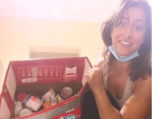 Claire Matlock of Kitchener, Ont., says she and her best friend, both Canadian medical students in St. Vincent, sprang into action to volunteer to get supplies to evacuees following Friday's volcanic eruption of La Soufrière on the Caribbean island. (Submitted by Claire Matlock - image credit)