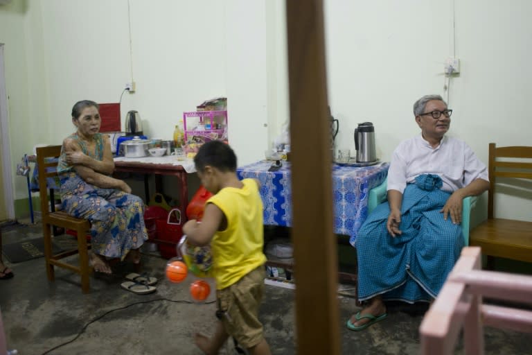 Myanmar member of parliament Ohn Kyaingare, 72, (R) talks with his family in lodgings provided by the government for MPs in Naypyidaw on August 24, 2015