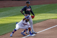 New York Mets' Amed Rosario, front, reacts in front of Atlanta Braves third baseman Johan Camargo after hitting an RBI-triple during the fifth inning of a baseball game Saturday, July 25, 2020, in New York. (AP Photo/Adam Hunger)
