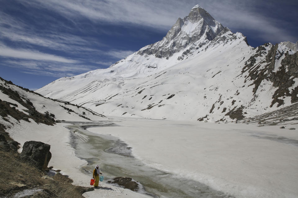 Mouni Baba, a Hindu holy man, fetches water from a stream at the feet of Mount Shivling in Tapovan, at an altitude of 4500 meters in the northern Indian state of Uttarakhand, Friday, May 10, 2019. Mouni Baba, on a silent vow, has been meditating in Tapovan for years, even during the long months when winter makes the place inaccessible. Tapovan is located just above Gangotri glacier, which is one of the primary sources of water for the Ganges. (AP Photo/Altaf Qadri)