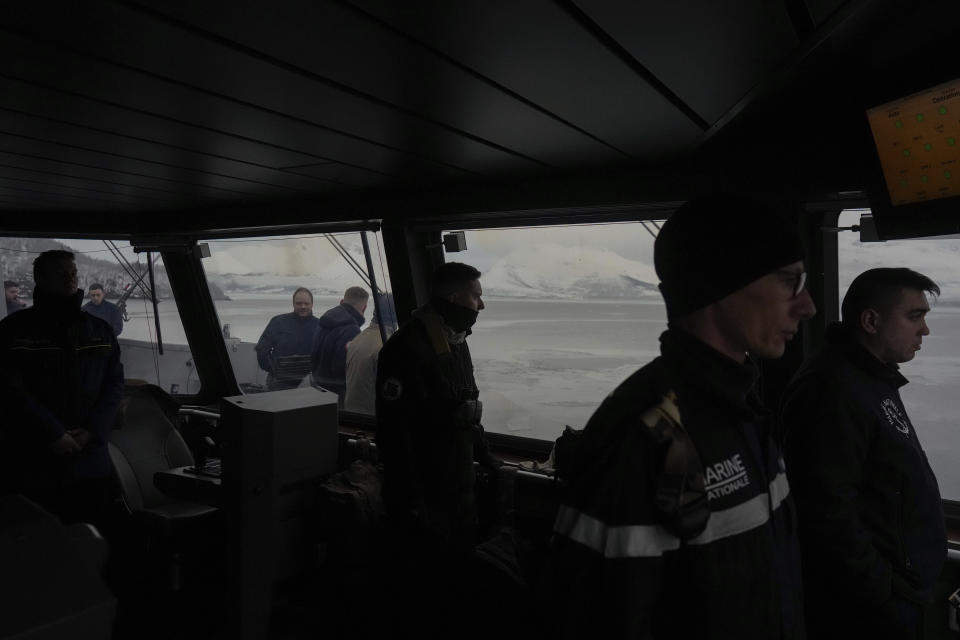 French sailors watch the docking manoeuvre of the French navy frigate Normandie for a port call in a Norwegian fjord, north of the Arctic circle, Friday March 8, 2024. The French frigate is part of a NATO force conducting exercises in the seas, north of Norway, codenamed Steadfast Defender, which are the largest conducted by the 31 nation military alliance since the cold war. (AP Photo/Thibault Camus)