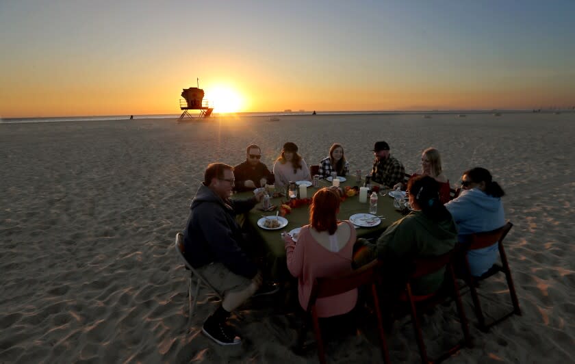 HUNTINGTON BEACH, CA. - NOV. 25, 2020. Members of the Hobbs-Brown family celebrate Thanksgiving dinner on the sand at Bolsa Chica State Beach on Wednesday, Nov. 25, 2020. (Luis Sinco/Los Angeles Times)